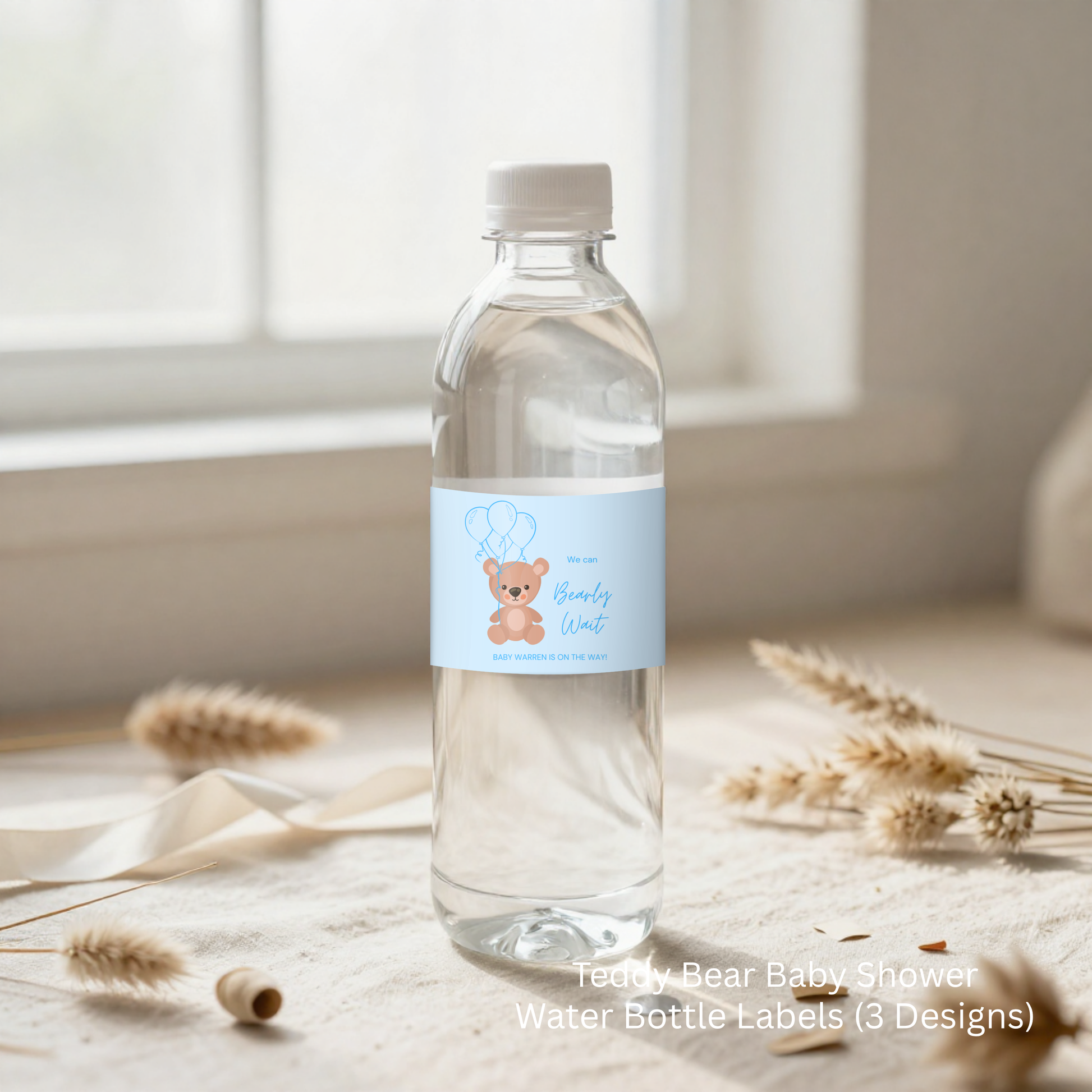 Clear water bottle with a blue label featuring a teddy bear design on a light wooden surface.