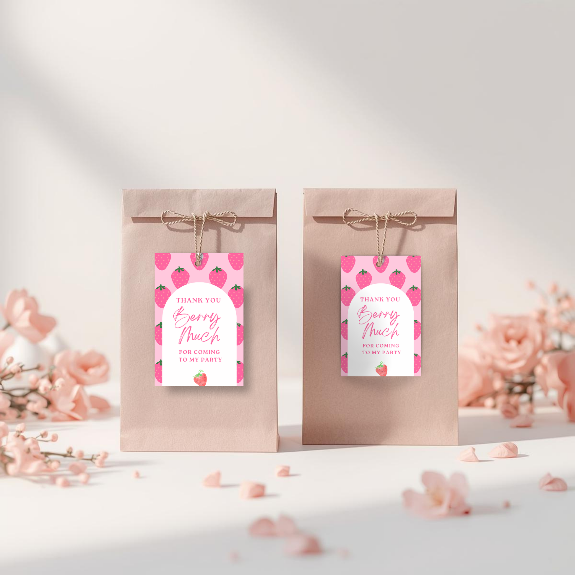 Two gift bags with pink floral tags on a white background