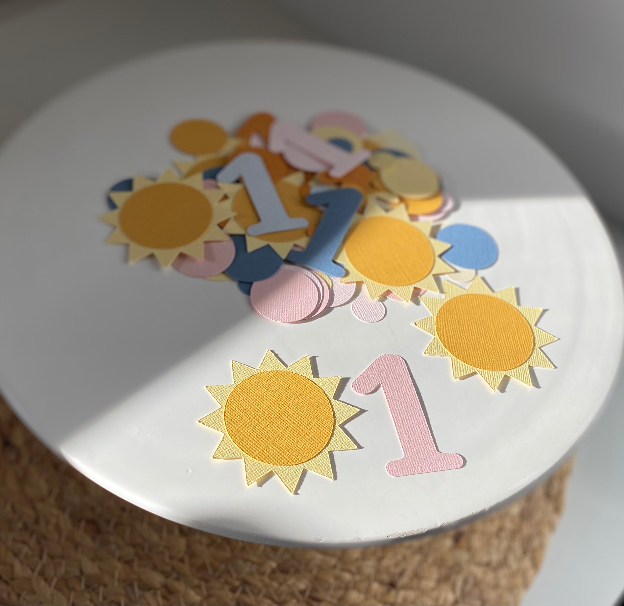 Sun-shaped confetti pieces in yellow and orange for kids' birthday parties
