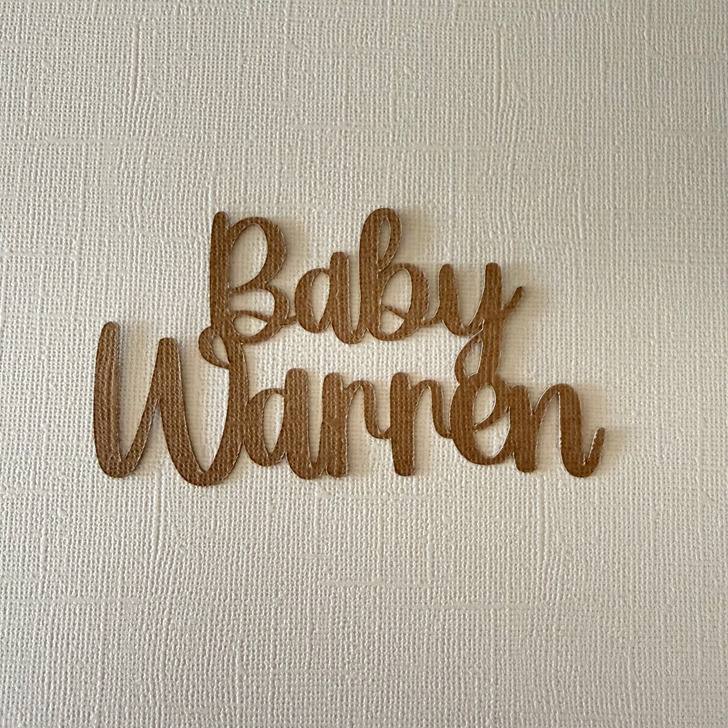 Personalised baby surname name with 'Baby Warren' on a textured beige background
