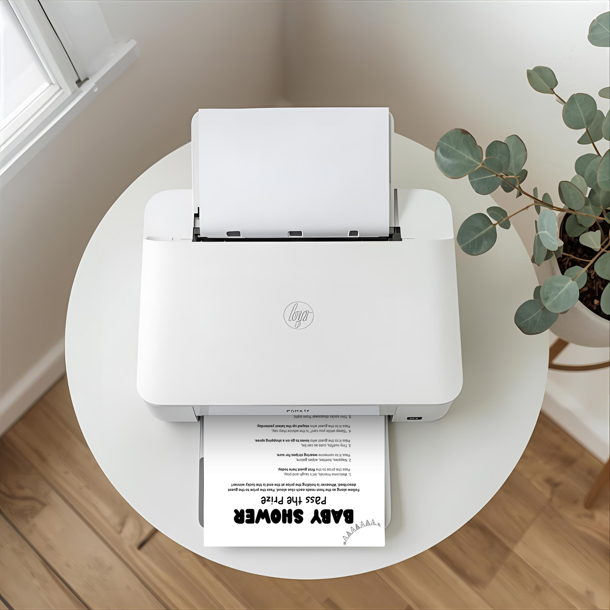 A white HP mini printer sits on a round white table in a bright room, with a sheet of paper inserted at the top and another printed sheet coming out. A potted eucalyptus plant is visible on the right, and a window and wood floor are in the background.
