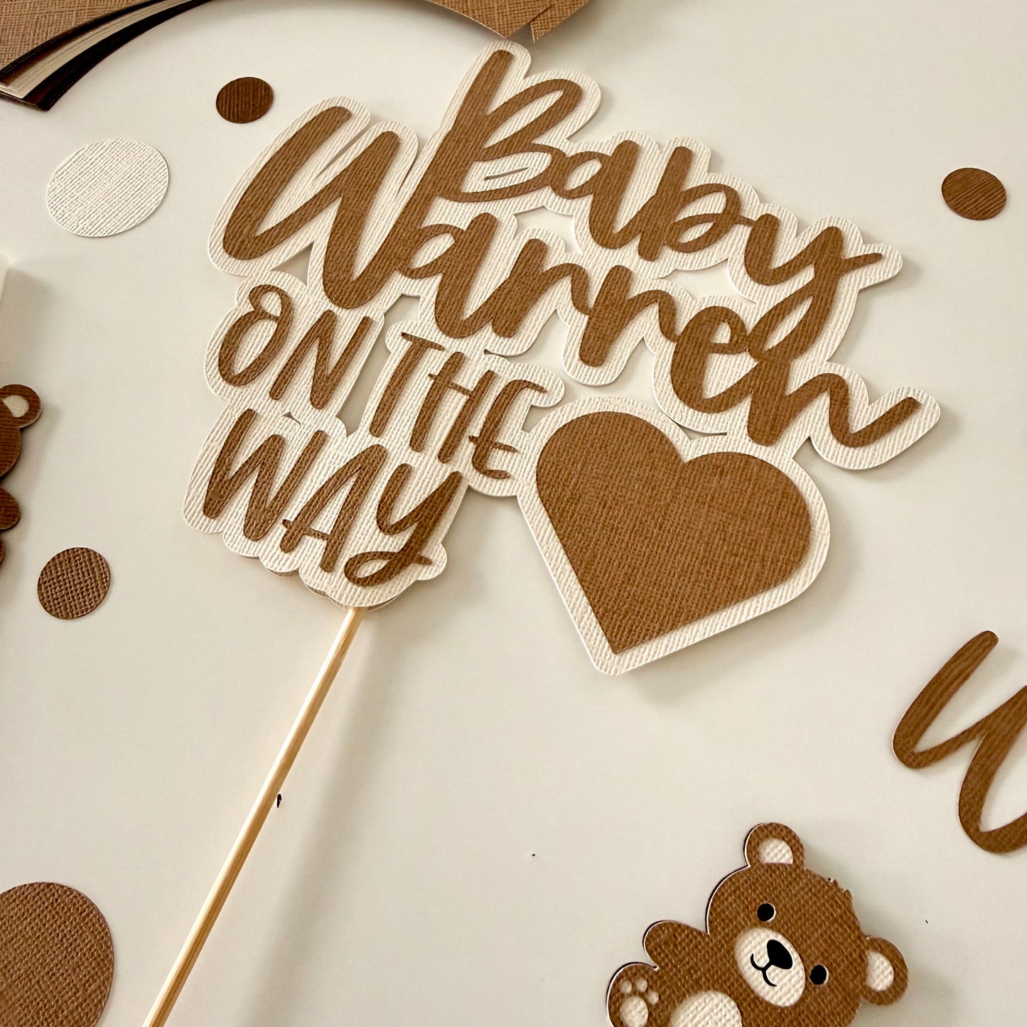 Baby shower decoration with 'Baby on the Way' text and heart design.