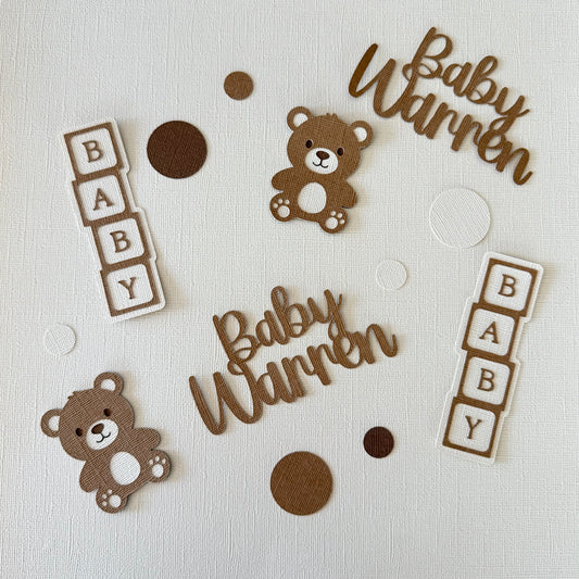 Decorative elements for a baby-themed design with teddy bears and 'Baby Warren' text on a light background.