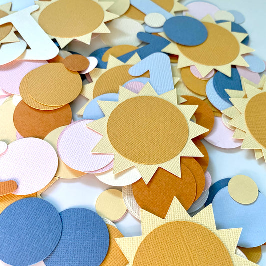 Colorful sun-shaped paper cutouts on a white background